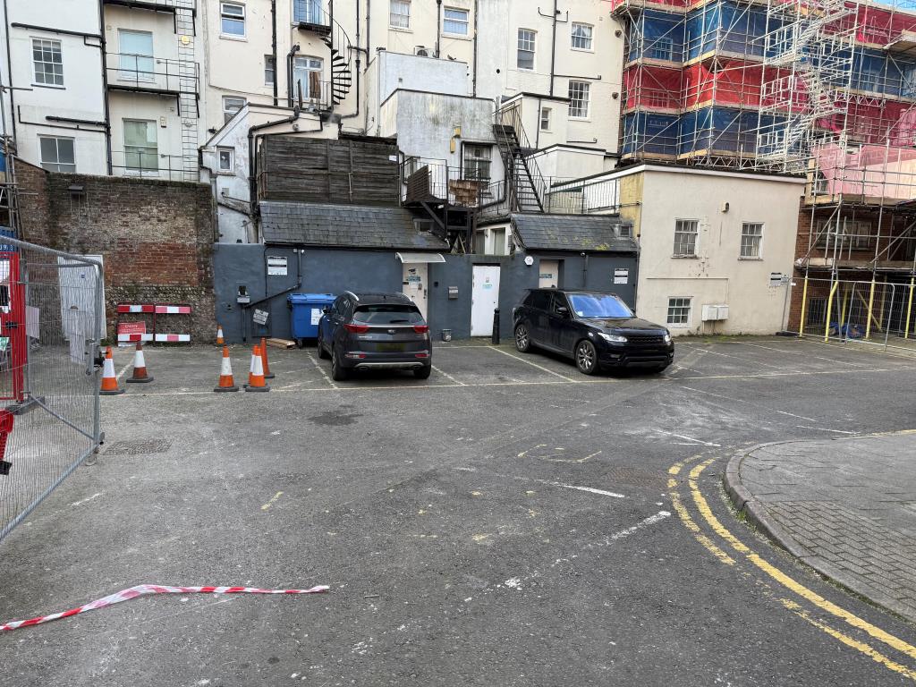 Lot: 79 - NINE CAR PARKING SPACES IN CITY CENTRE LOCATION - View of car spaces with two cars parked
